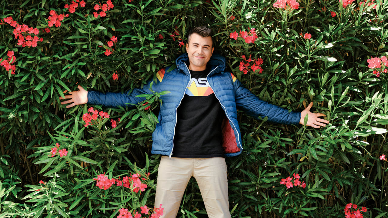 Photo of Mark Rober Laying Against Flowers Outside